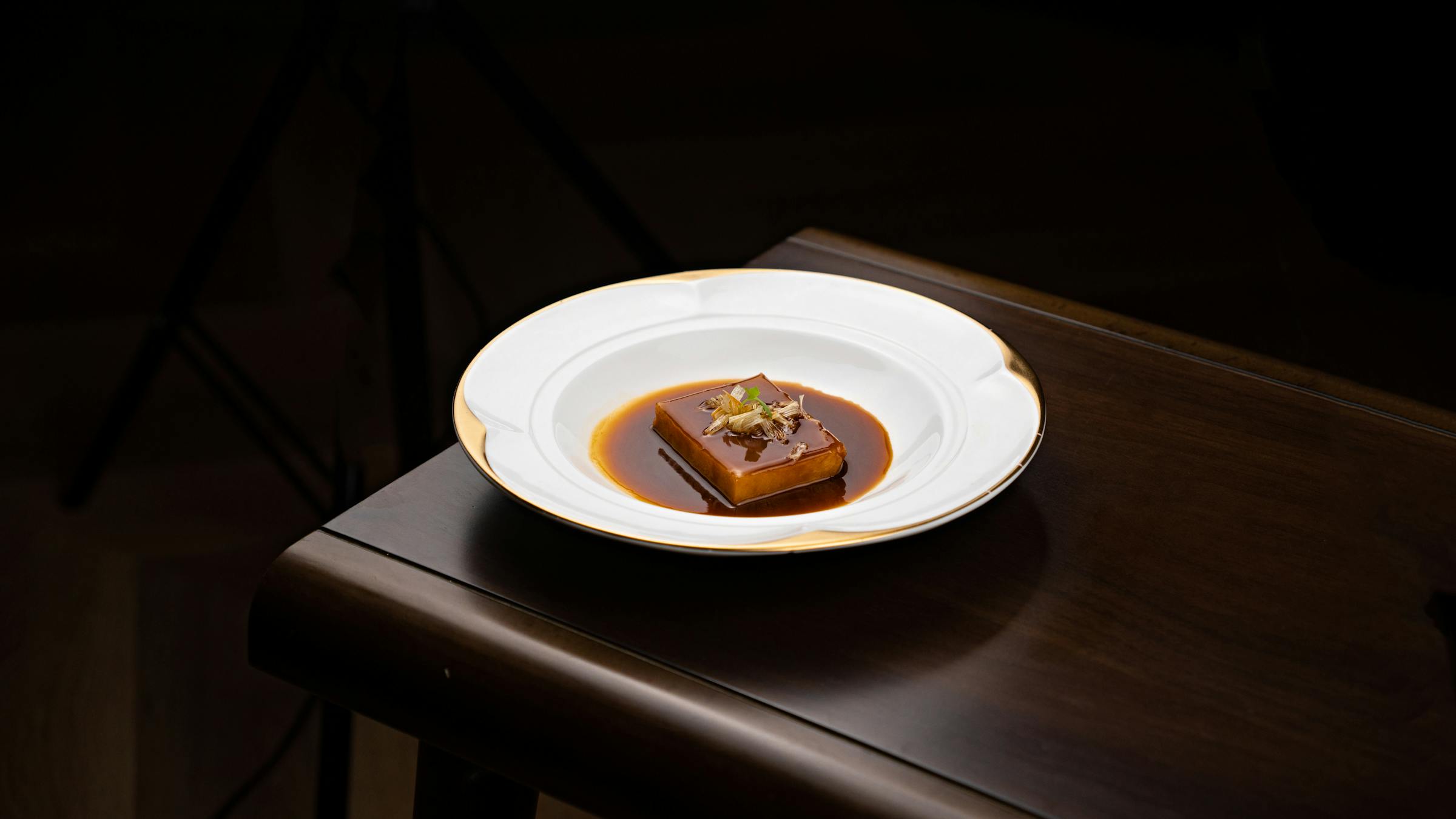 Chef arranging a spring dish with edible flowers at Sensoria House